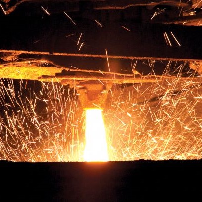 sparks fly as molten metal pours from nozzle